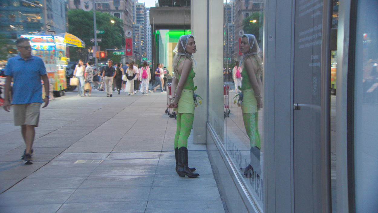 The audience watching a New York street through a storefront window